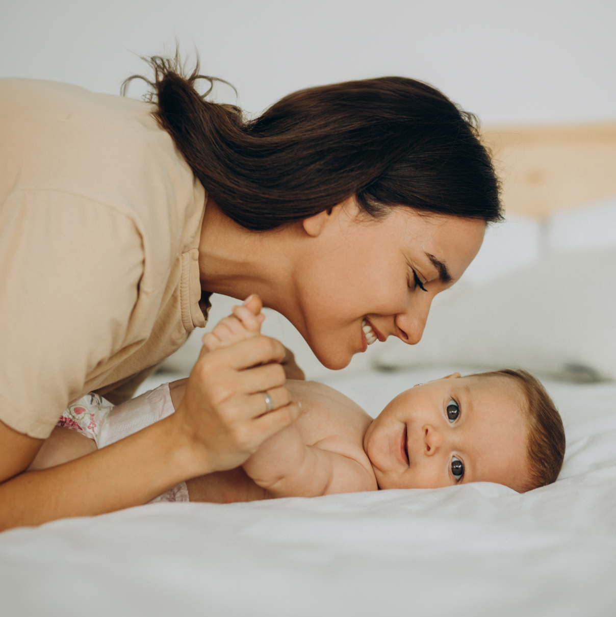 mom and child lying on bed